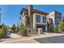 Modern two-story home featuring stone accents, wood siding, and a well-manicured front yard at 10119 Bellwether Ln, Lone Tree, CO 80124