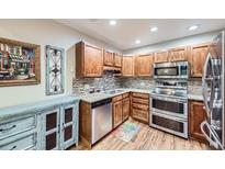 Charming kitchen features wood cabinets, granite countertops, and stainless steel appliances at 3022 S Wheeling S Way # 410, Aurora, CO 80014