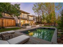 Picturesque backyard with a pool, patio, and basketball hoop at 19 S Eudora St, Denver, CO 80246