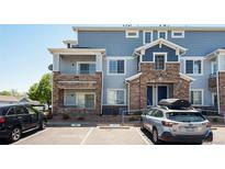 Inviting exterior of a multi-story home with stone accents and a private balcony at 5255 Memphis St # 315, Denver, CO 80239