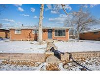 Brick ranch home with a snow-covered yard and mature trees at 3345 W Aqueduct Ave, Littleton, CO 80123