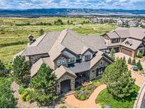 Luxury home with mountain views, landscaped grounds, and a large backyard at 10887 Rainribbon Rd, Highlands Ranch, CO 80126