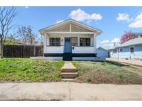 Charming home with a welcoming porch and a bright blue front door, set on a well-maintained lawn at 45 S Grove St, Denver, CO 80219