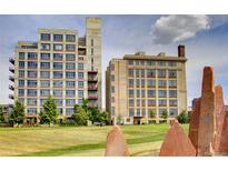 This is an image showing two apartment buildings from a ground-level outdoor view with landscaping in the foreground at 2000 Little Raven St # 1B, Denver, CO 80202