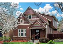 Charming two-story brick home with colorful shingles and a well-maintained front yard, showcasing curb appeal at 2927 N Humboldt St, Denver, CO 80205