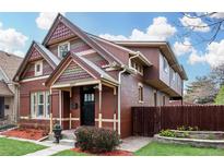 Inviting two-story brick home with a charming front porch and well-maintained landscaping at 2927 N Humboldt St, Denver, CO 80205