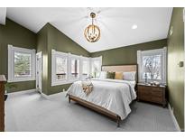 Spacious main bedroom featuring white carpet, decorative wall trim and large windows with shutters at 2927 N Humboldt St, Denver, CO 80205