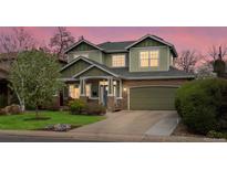 Charming two-story home with a well-manicured lawn, stone accents, and attached two car garage at 810 Jasmine St, Denver, CO 80220