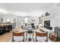 Cozy living room featuring a brick fireplace and modern decor, perfect for relaxing or entertaining at 11 S Albion St, Denver, CO 80246