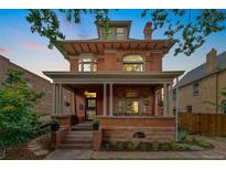 Charming red brick home with a welcoming front porch and detailed architectural features at 1154 N Clarkson St, Denver, CO 80218