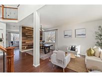 Bright living room with hardwood floors and ample natural light at 12773 E 105 Th Pl, Commerce City, CO 80022