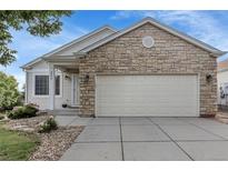 Charming home with stone accents, covered porch, two car garage and well-kept landscaping at 2659 S Halifax St, Aurora, CO 80013