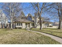 Stunning two-story home with manicured lawn and mature trees at 2 Elm St, Denver, CO 80220