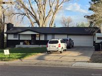 Charming single-story home with a well-maintained front yard and a two car garage at 6948 W 70Th Ave, Arvada, CO 80003