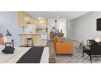 Inviting living area boasts an open layout, a well-equipped kitchen, a desk area, and stylish decor at 2500 S York St # 410, Denver, CO 80210
