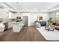 Open concept kitchen and living area, featuring modern appliances and hardwood floors at 5360 Allison St # D, Arvada, CO 80002