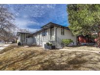 Inviting painted brick duplex with professional landscaping and meticulous attention to detail at 4001 Wyandot St, Denver, CO 80211