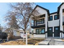 Modern townhome showcasing black-framed windows, black trim, and a welcoming front yard at 2321 S Galapago St, Denver, CO 80223