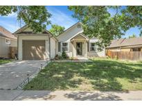 Charming single-Gathering home with a well-maintained front yard and an attached two-car garage, with a lovely lawn at 17499 E Whitaker Dr, Aurora, CO 80015