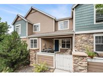 Charming townhome exterior featuring stone accents and a cozy front porch at 13275 Holly St # B, Thornton, CO 80241