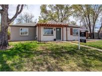 Charming ranch-style home featuring a well-maintained lawn and inviting entrance at 6220 W 11Th Pl, Lakewood, CO 80214