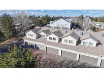 An aerial view of townhome garages with gray doors and light siding on a sunny day at 12327 E Tennessee Dr # 107, Aurora, CO 80012