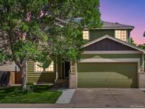 Charming two-story home with a well-maintained lawn and attached two-car garage at 11082 Fillmore Way, Northglenn, CO 80233