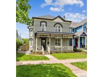 Charming two-story home features a covered front porch and a well-manicured lawn at 1016 31St St, Denver, CO 80205