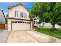 Charming two-story home with a well-maintained lawn and a large driveway leading to a two-car garage at 7796 Xavier Ct, Westminster, CO 80030