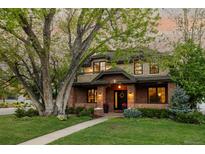 Charming two-story brick home with a large front yard and mature tree at 301 Fairfax St, Denver, CO 80220