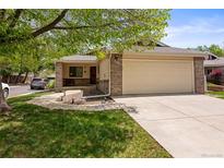 Charming single-story home with an attached two-car garage and a well-manicured lawn at 8040 E Dartmouth Ave # 16, Denver, CO 80231
