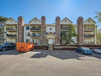 Apartment building with brick chimney stacks and balconies overlooking the parking area at 15911 E Dakota Pl # 301, Aurora, CO 80017