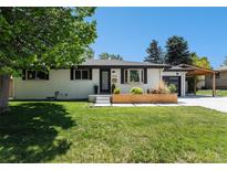 Charming painted-brick home with modern planters, black trim, and a well-manicured lawn at 6538 S Lee Ct, Centennial, CO 80121
