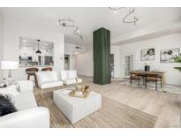 Modern living room with open floor plan, stylish furniture, and large windows at 475 W 12Th Ave # 6B, Denver, CO 80204