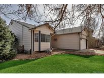 Charming home exterior with well-maintained lawn, stone landscaping, and attached garage at 2132 Boise Ct, Longmont, CO 80504