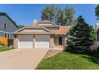 Charming two-story home featuring a two-car garage and well-maintained front lawn at 9948 King St, Westminster, CO 80031