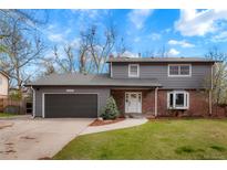 Charming two-story home with a gray exterior, attached garage, and well-maintained front yard at 4682 Chatham St, Boulder, CO 80301