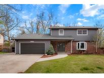 Charming two-story home featuring gray siding, a brick facade, mature landscaping, and an attached two-car garage at 4682 Chatham St, Boulder, CO 80301