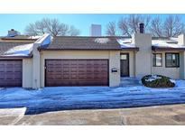 Exterior of charming townhome with brown garage door and snow-covered driveway at 1120 Cholla Ln, Broomfield, CO 80020
