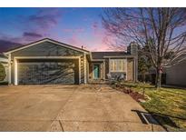 Charming single-Gathering home features a well-maintained yard and an attached two-car garage at 8893 W Ontario Ave, Littleton, CO 80128