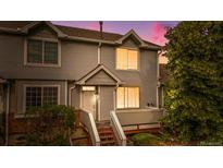 Charming townhome with gray siding, well-lit windows, and inviting front entrance at 4070 E 119Th Pl # B, Thornton, CO 80233