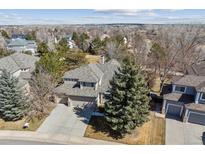 This is an aerial view of a lovely home in a treed neighborhood, with a large manicured yard and a welcoming driveway at 16302 Parkside Dr, Parker, CO 80134