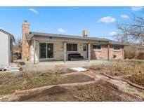 Home's brick patio features a covered seating area and a garden perfect for relaxation and entertaining at 2572 Beech Ct, Golden, CO 80401