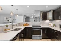 Modern kitchen featuring stainless steel appliances, subway tile backsplash, and quartz countertops at 2572 Beech Ct, Golden, CO 80401