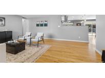 Bright living room features hardwood floors and stylish accent furniture at 2572 Beech Ct, Golden, CO 80401