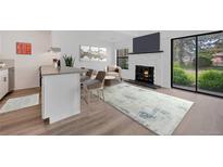 Stylish living area featuring a fireplace, TV, open to eat-in kitchen area and sliding glass doors at 225 E 8Th Ave # A2, Longmont, CO 80504