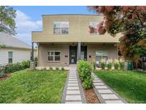 Contemporary home with brick accents, manicured lawn and a modern walkway leading to the entrance at 2935 S Sherman St, Englewood, CO 80113