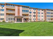 Attractive exterior of a mid-rise apartment building with landscaping at 300 S Clinton St # 8C, Denver, CO 80247