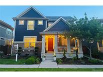 Charming two-story home with a welcoming front porch, landscaped yard, and attractive curb appeal at 9456 E 51St Dr, Denver, CO 80238