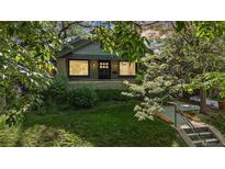 Charming home featuring a well-manicured front yard with lush greenery, landscaping, and inviting curb appeal at 756 Steele St, Denver, CO 80206